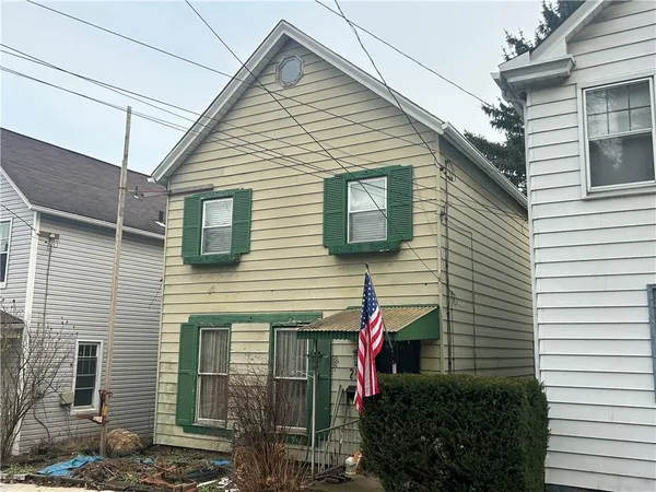 a front view of a house with plants