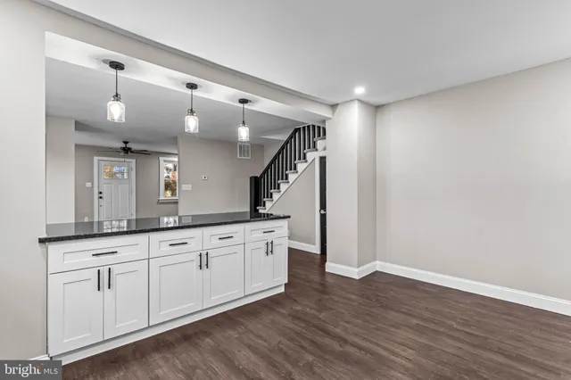 a spacious bathroom with a granite countertop sink and a mirror