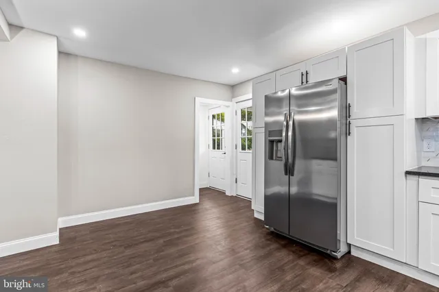 a kitchen with stainless steel appliances granite countertop a refrigerator and a refrigerator