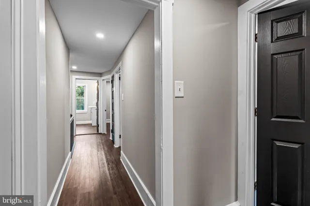 a view of hallway with wooden floor