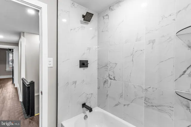 a bathroom with a bathtub and a shower