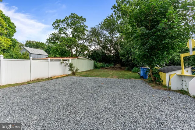 a backyard of a house with portable swimming pool and basket ball court