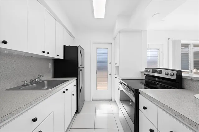 a kitchen with a sink and a stove top oven