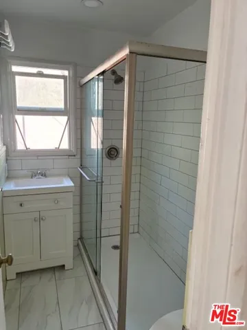 a bathroom with a shower and a sink