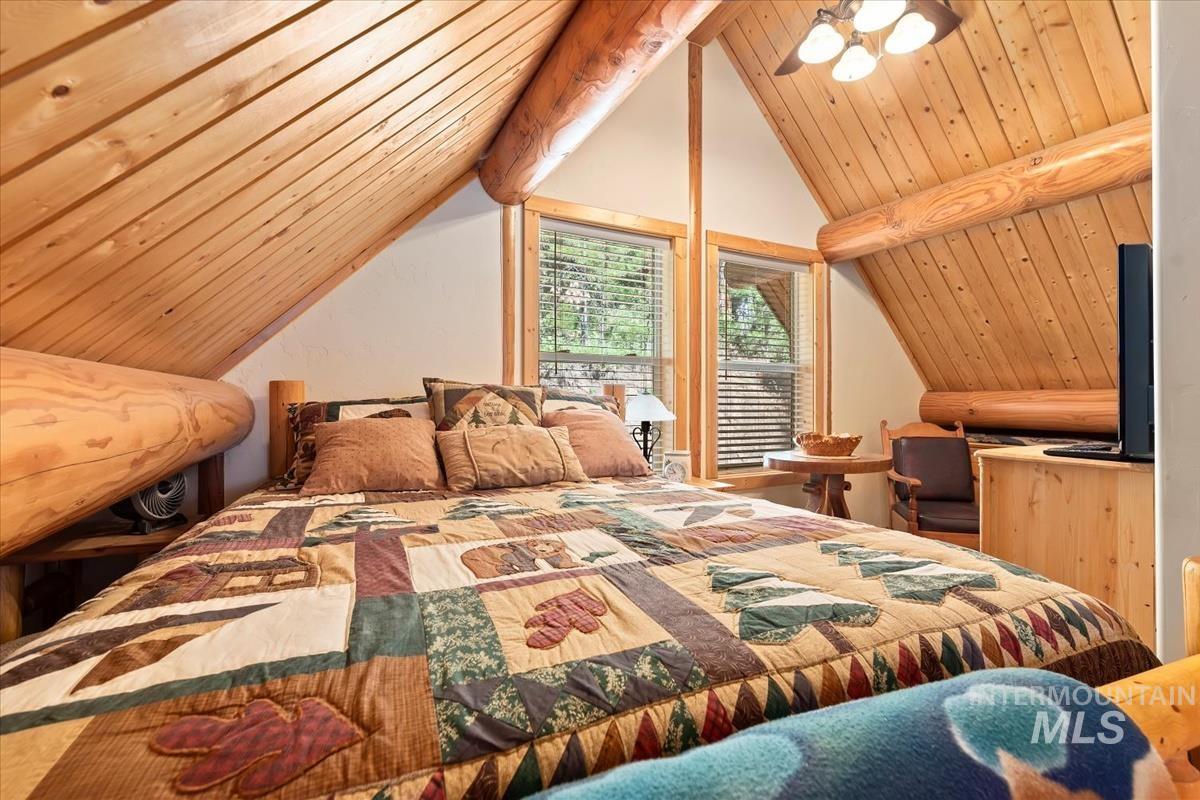 10 Elk Point Road Garden Valley, ID 83622 - Photo 27 of 42 Bedroom with ceiling fan and a wood ceiling with exposed beams