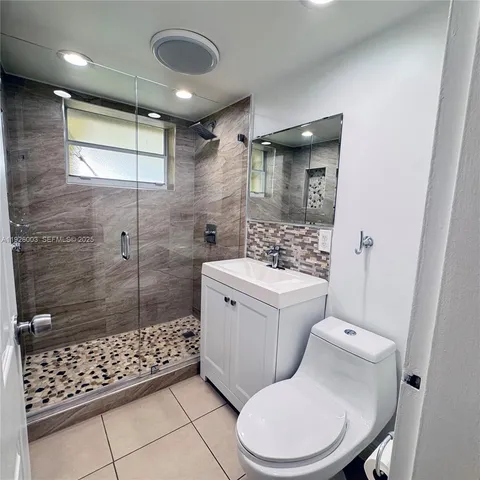 a bathroom with a toilet sink and shower