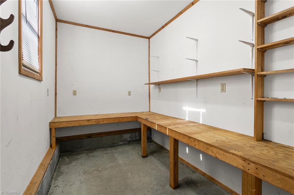 7021 Eaglesfield Road Gibsonville, NC 27249 - Photo 46 of 49 A fourth garage room offering a built-in workbench and flexible space for small projects or storage.