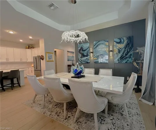 a view of a dining room with furniture and chandelier