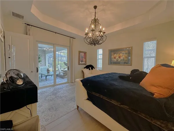 a bed room with furniture and a chandelier