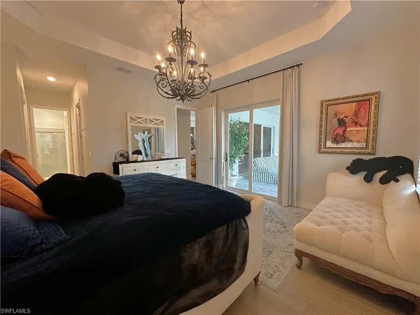 a bedroom with a bed mirror and window