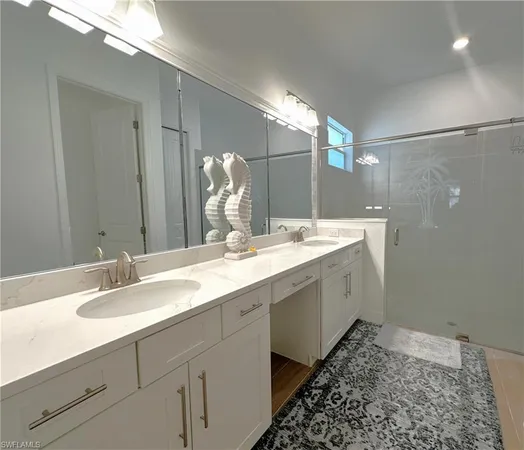 a spacious bathroom with a double vanity sink and mirror