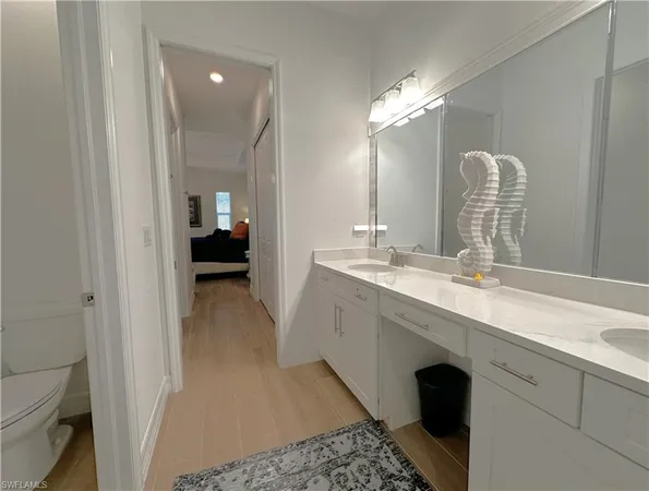 a en suite bathroom with a double vanity sink and a mirror