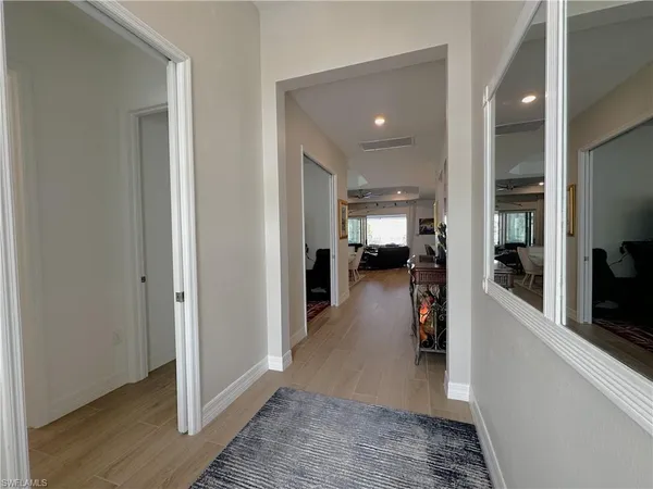 a view of a hallway with furniture and a living room