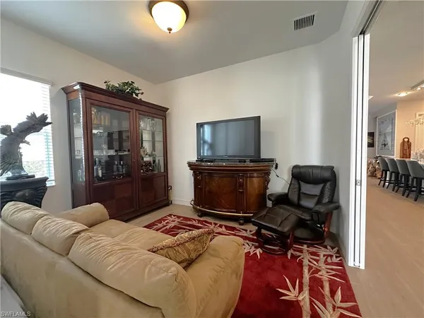 a living room with furniture a flat screen tv and a floor