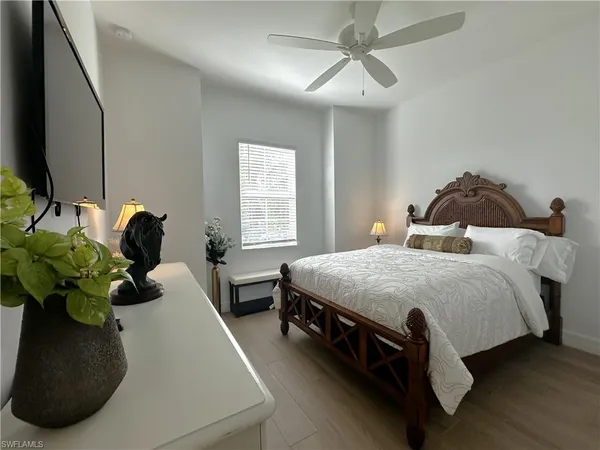 a bed room with a bed and a chandelier