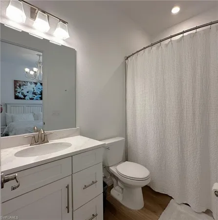 a bathroom with a toilet a sink and a mirror