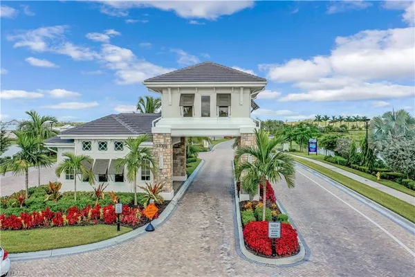 a view of a white house with large windows and a table