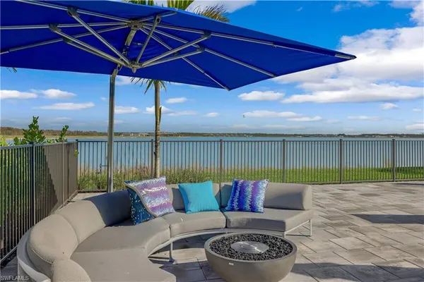 a roof deck with a table and chairs under an umbrella