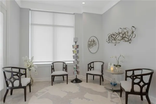 a view of a room with a table and chairs