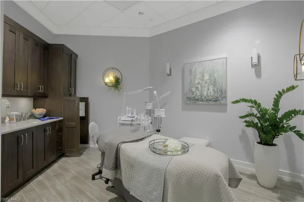 a bedroom with a bed and a potted plant