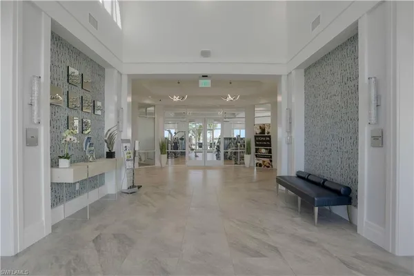 a lobby with furniture and floor to ceiling window