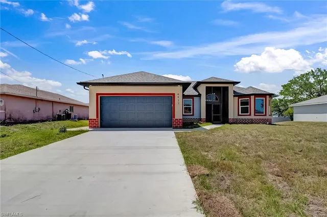 a front view of a house with a yard and garage