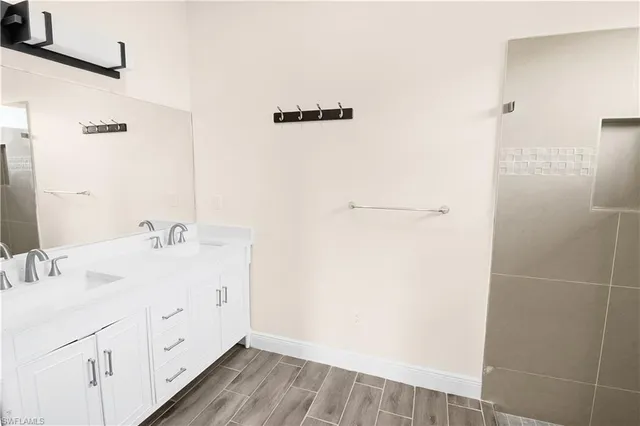 a bathroom with a glass shower door