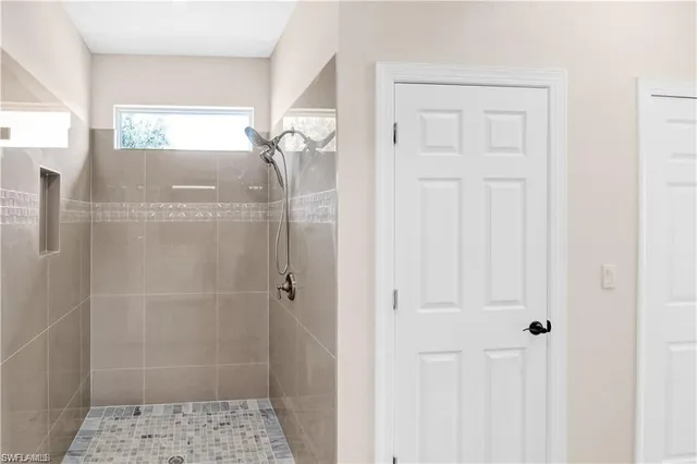 a bathroom with a glass shower door