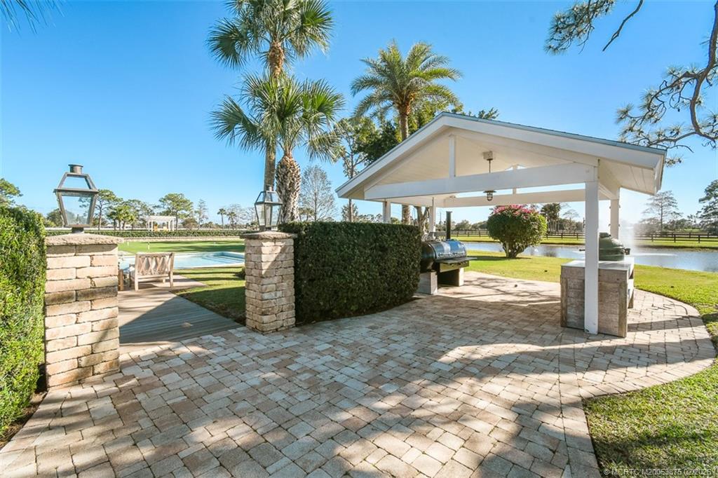 2541 Southwest Trailside Path Stuart, FL 34997 - Photo 79 of 100 a view of a house with backyard porch and sitting area
