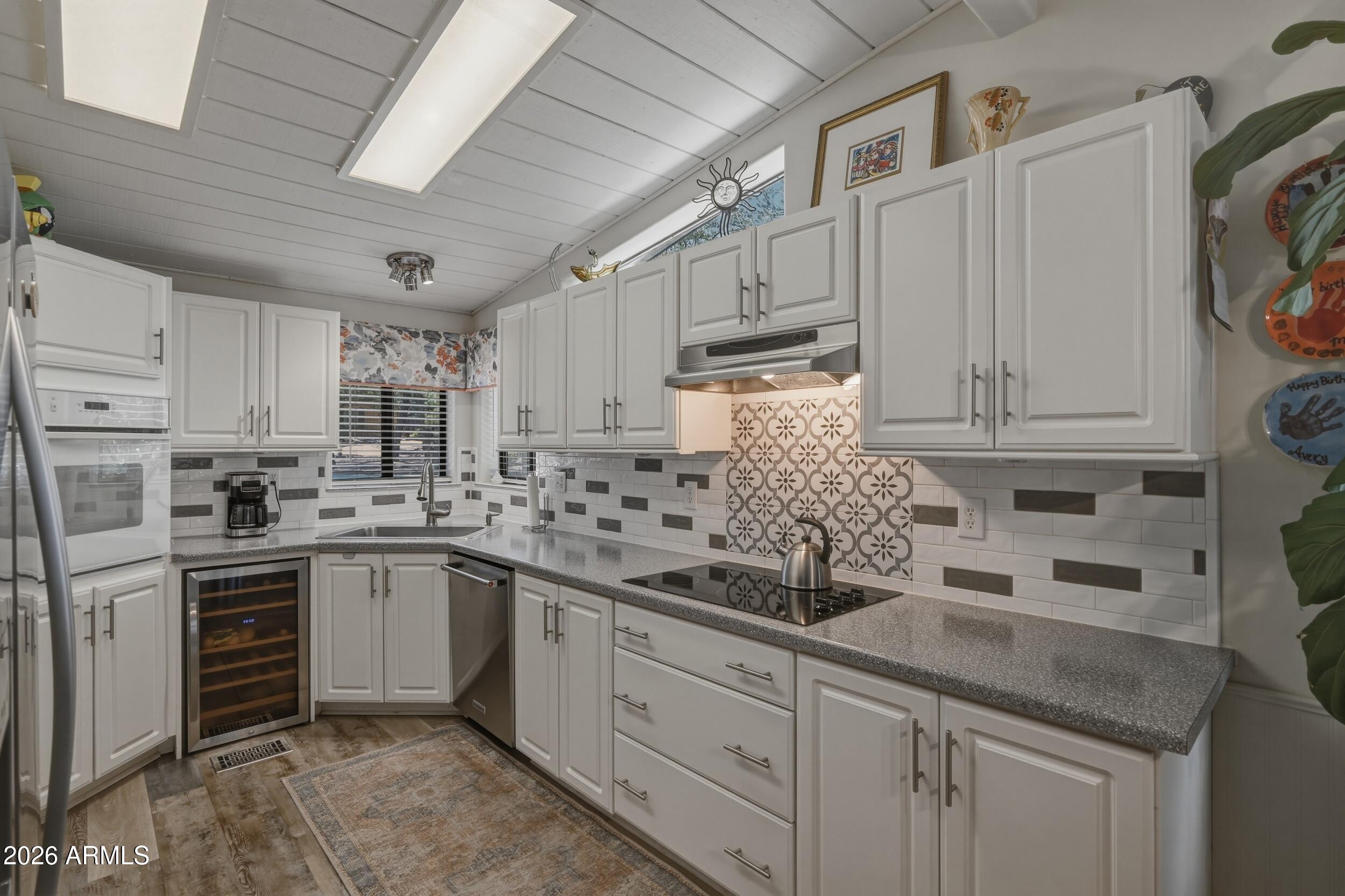 1108 North William Tell Circle Payson, AZ 85541 - Photo 9 of 32 a kitchen with white cabinets and white appliances