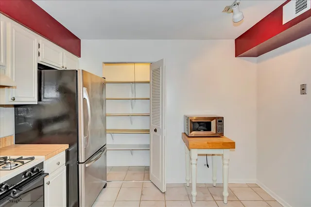 a kitchen with a sink cabinets and appliances