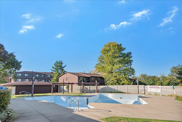 a swimming pool with outdoor seating and yard