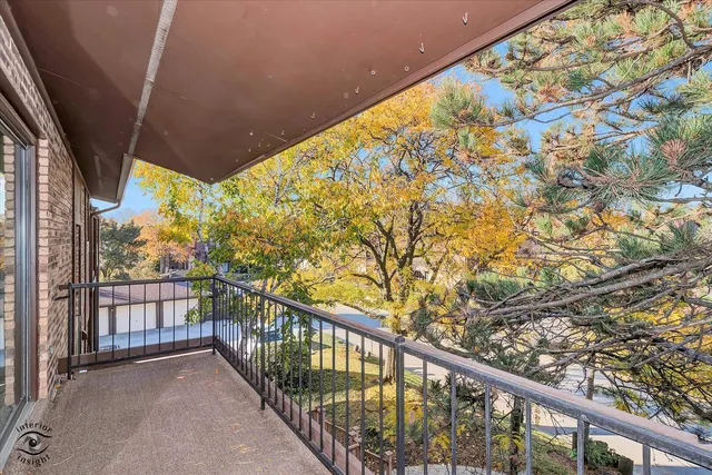a view of balcony with wooden floor and fence