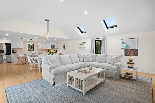 a living room with a fireplace and a floor to ceiling window