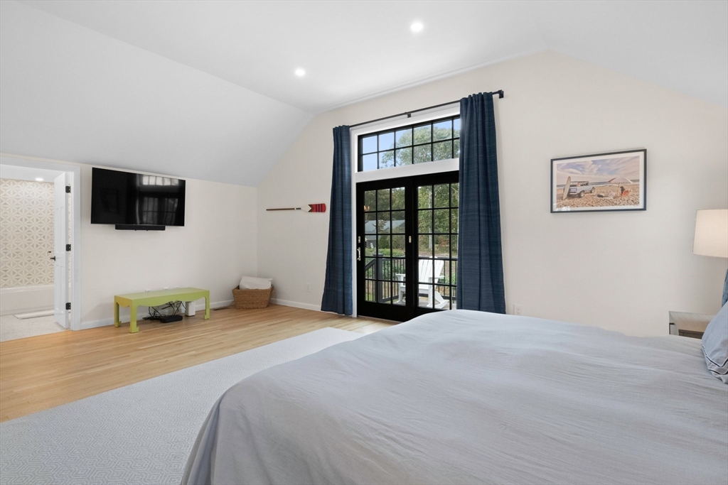 101 A Monomoyic Way Chatham, MA 02633 - Photo 19 of 42 a bedroom with a bed and a flat screen tv