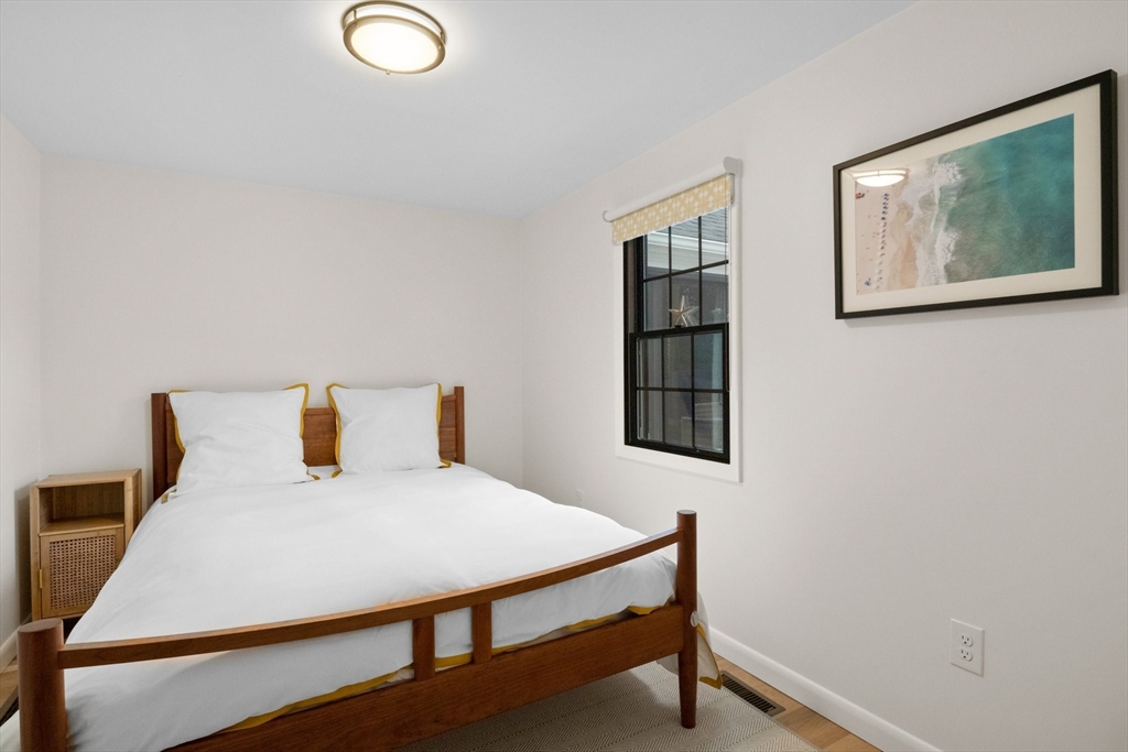 101 A Monomoyic Way Chatham, MA 02633 - Photo 24 of 42 a bedroom with a bed and painting on the wall