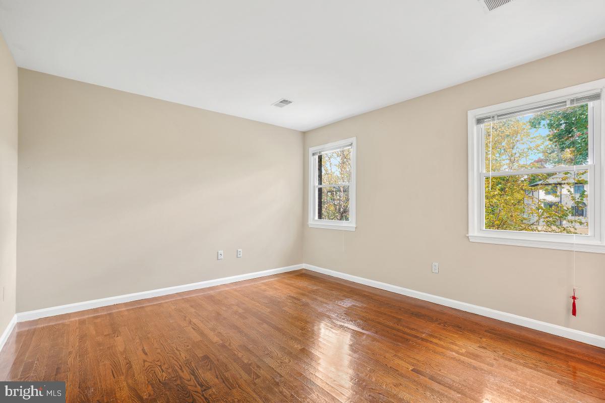 6871 Churchill Road McLean, VA 22101 - Photo 15 of 30 a view of an empty room with wooden floor and a window
