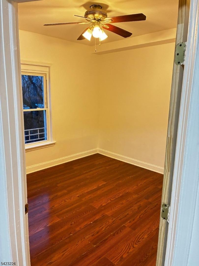 73 Wolcott Terrace Newark, NJ 07112 - Photo 15 of 20 a view of empty room with wooden floor and fan