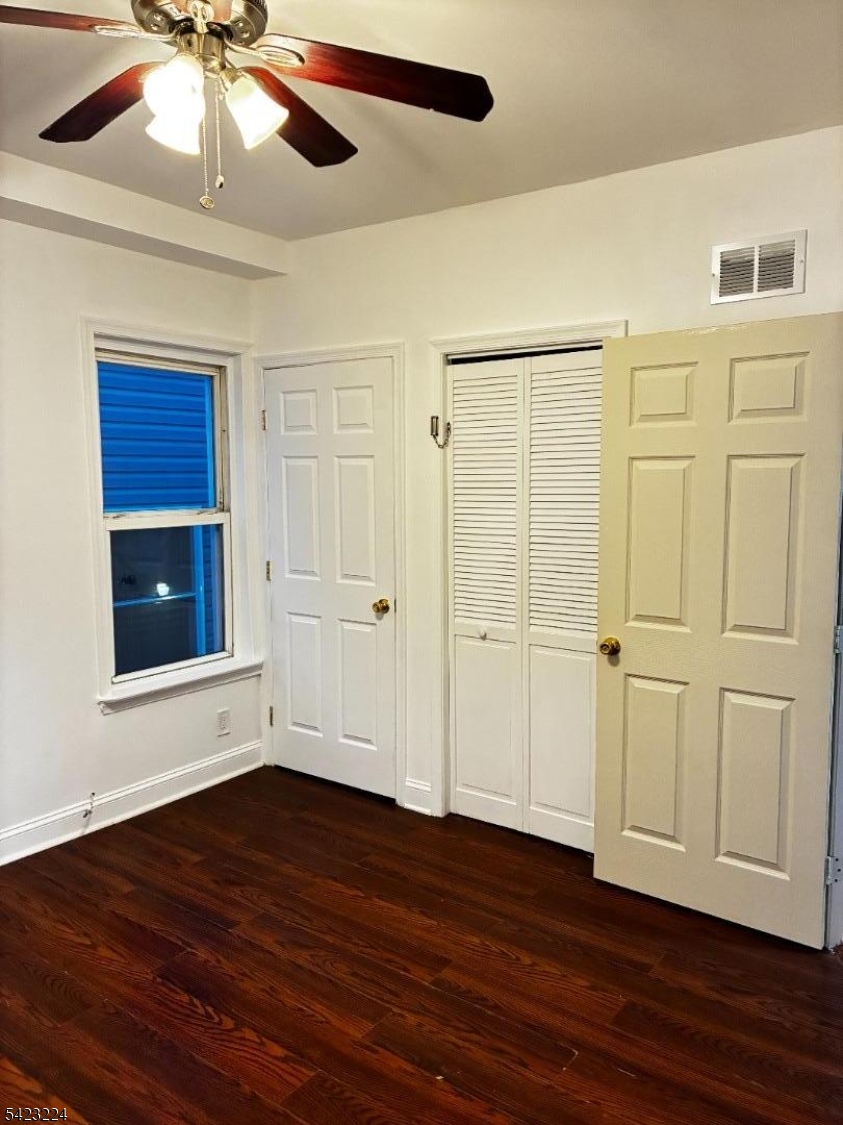 73 Wolcott Terrace Newark, NJ 07112 - Photo 16 of 20 a view of an empty room with wooden floor