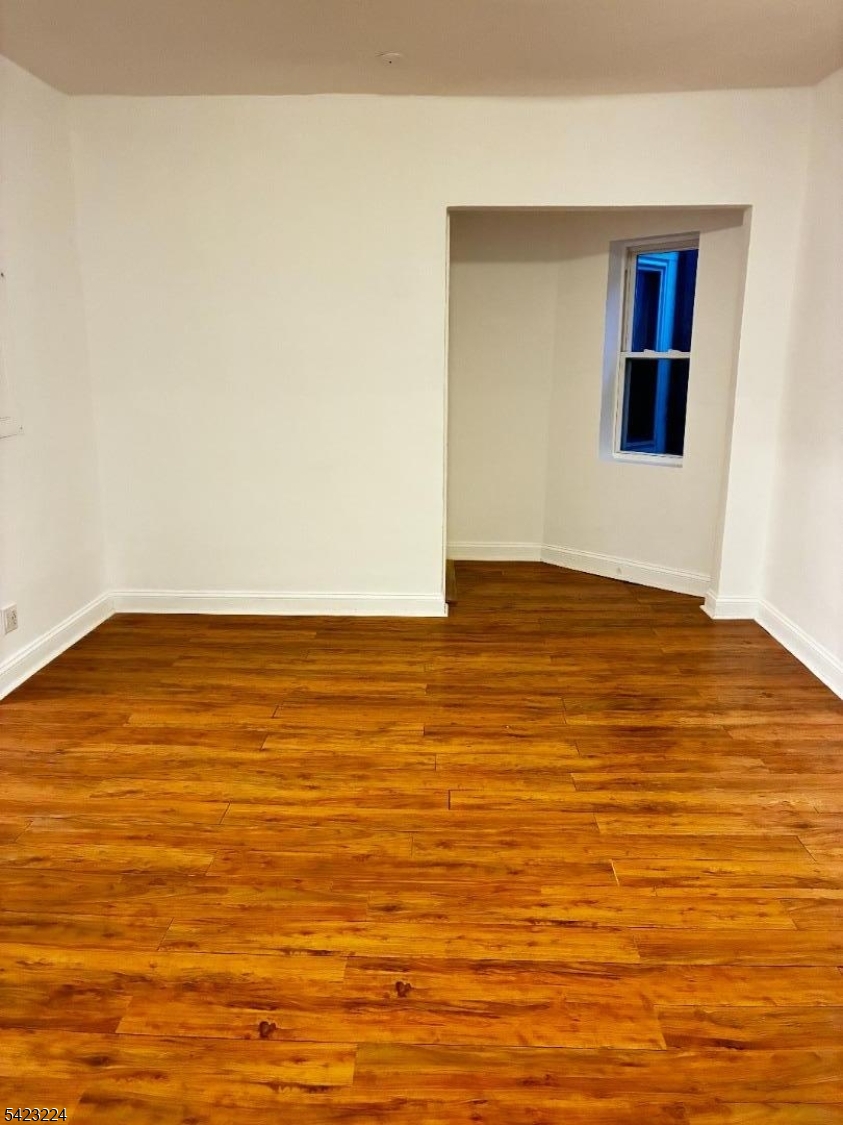 73 Wolcott Terrace Newark, NJ 07112 - Photo 2 of 20 a view of empty room with wooden floor