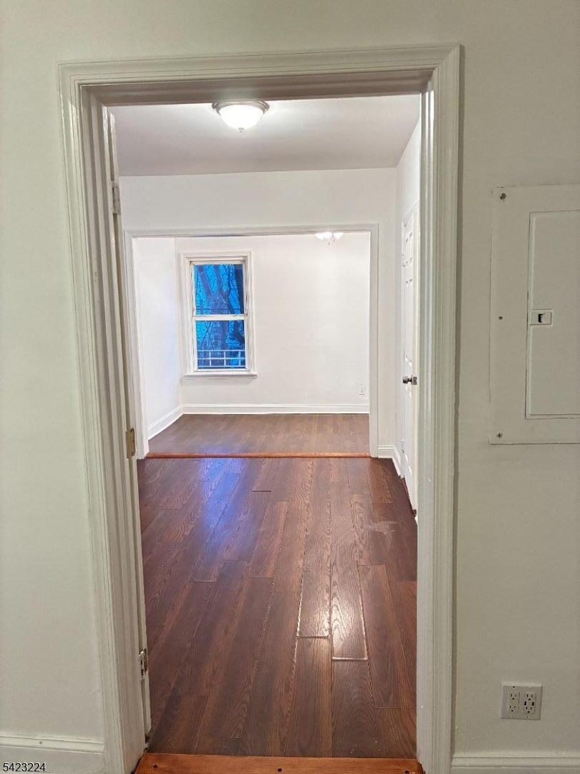 73 Wolcott Terrace Newark, NJ 07112 - Photo 3 of 20 a view of an empty room with wooden floor and a window