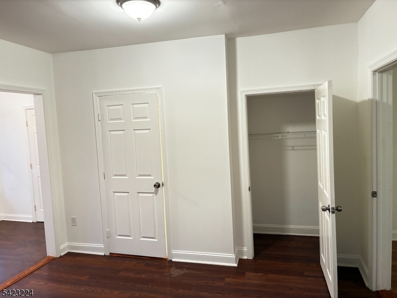 73 Wolcott Terrace Newark, NJ 07112 - Photo 6 of 20 an empty room with wooden floor & closet area