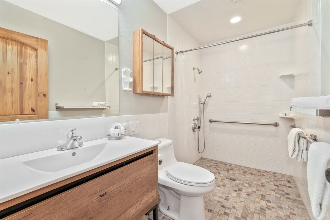 2025 Walton Creek Road, Unit 315 Steamboat Springs, CO 80487 - Photo 33 of 37 2nd bath with roll in shower, updated cabinet and tile.