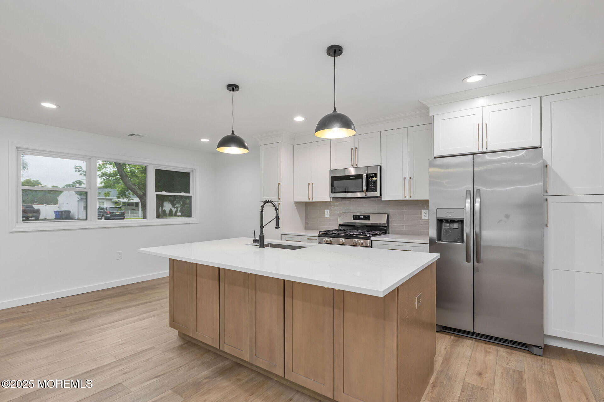 138 Stephan Road Brick, NJ 08724 - Photo 12 of 38 a kitchen with stainless steel appliances granite countertop a refrigerator a sink dishwasher a stove and white cabinets with wooden floor