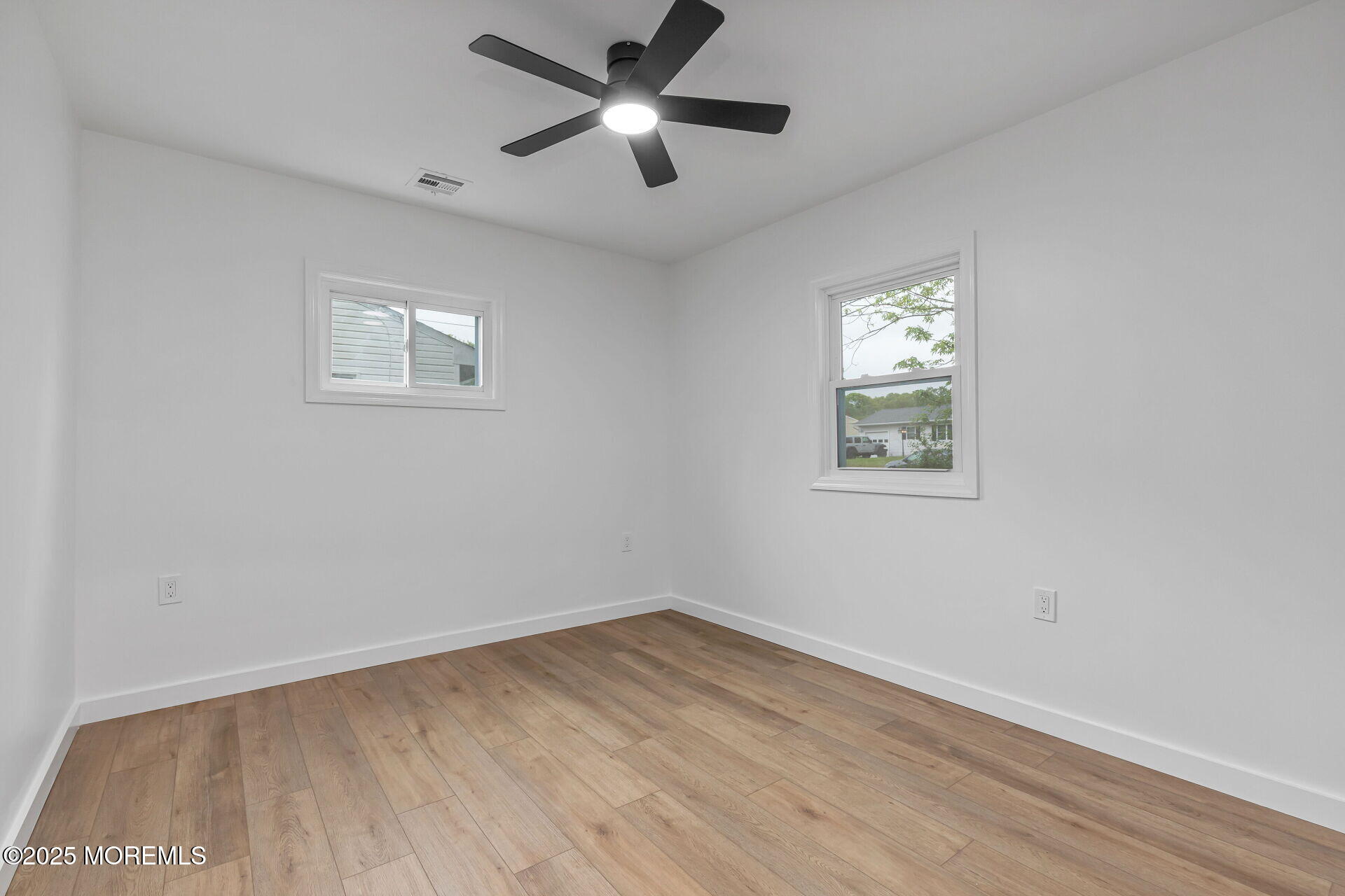 138 Stephan Road Brick, NJ 08724 - Photo 28 of 38 a view of empty room with wooden floor and fan