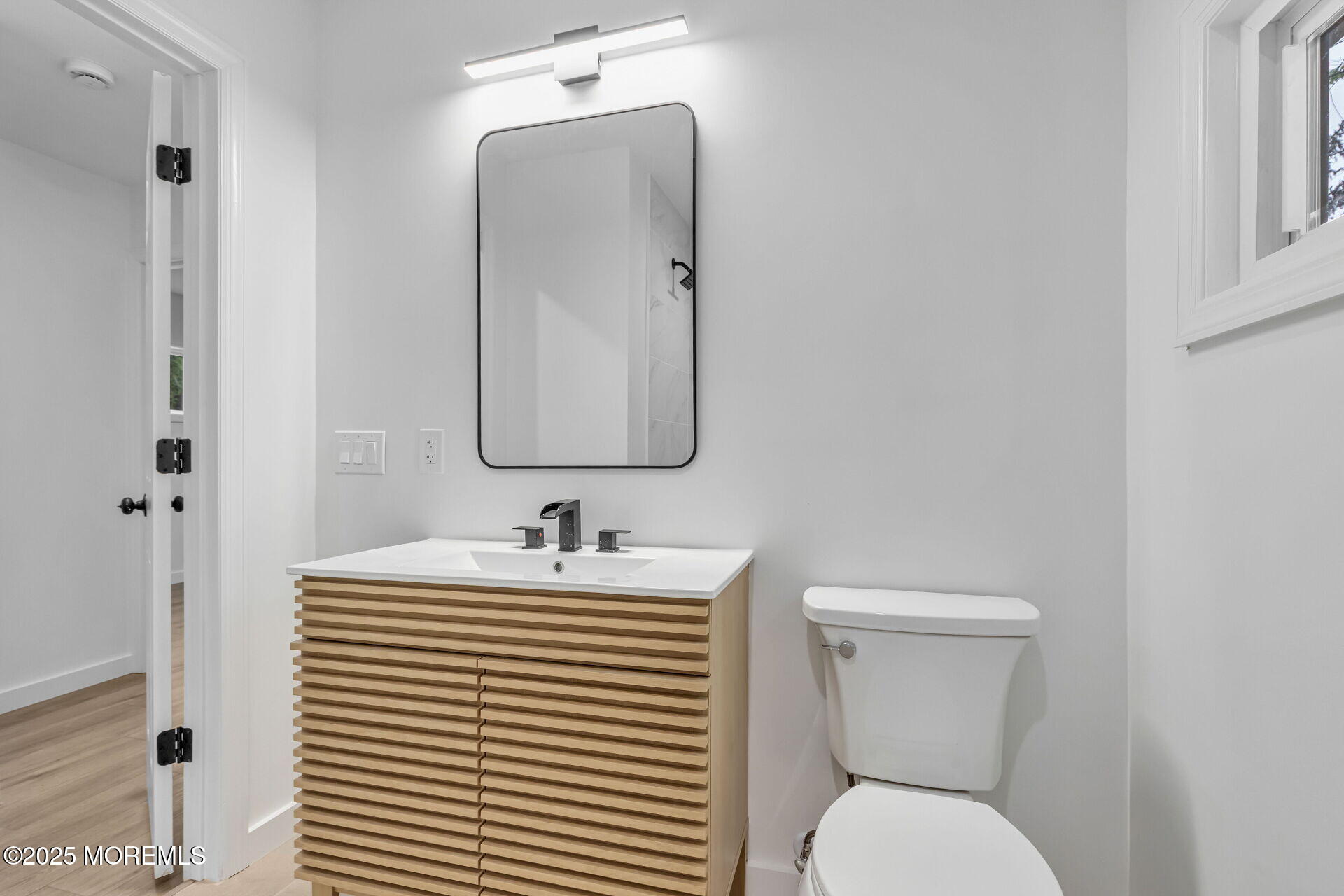 138 Stephan Road Brick, NJ 08724 - Photo 32 of 38 a bathroom with a toilet sink and mirror