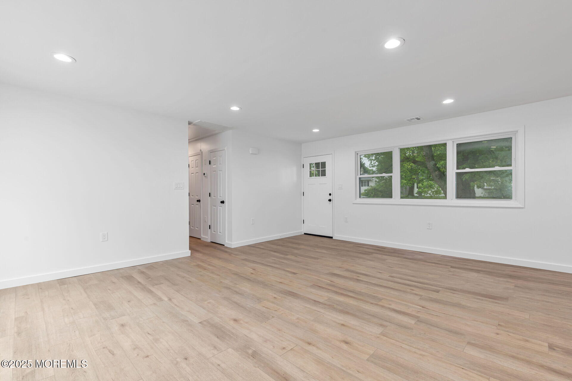138 Stephan Road Brick, NJ 08724 - Photo 8 of 38 an empty room with wooden floor and windows