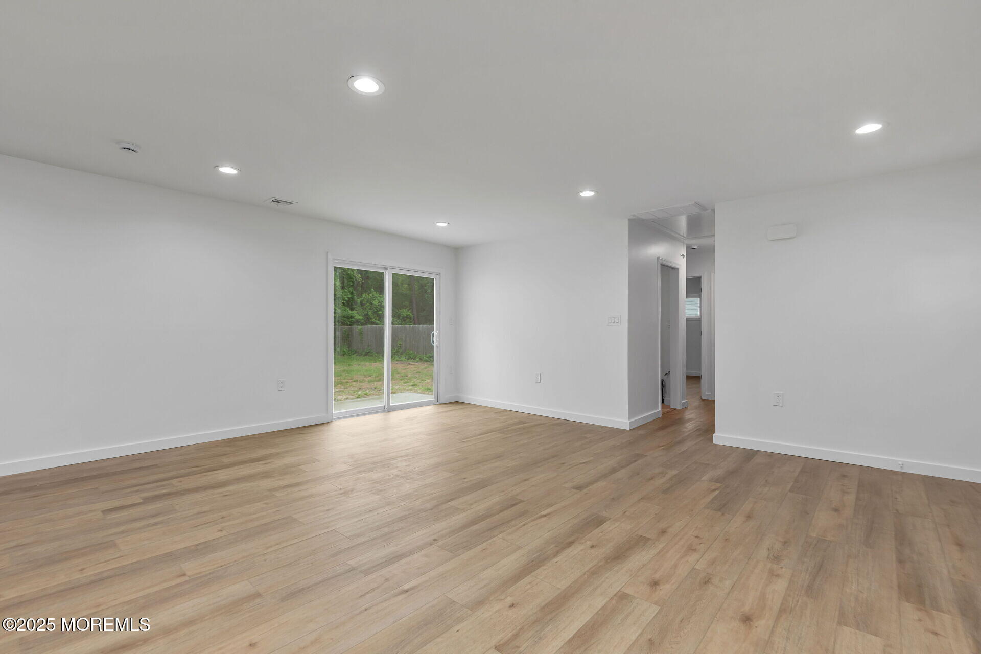 138 Stephan Road Brick, NJ 08724 - Photo 9 of 38 a view of an empty room with wooden floor and a window