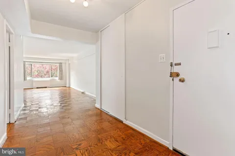 a view of empty room with wooden floor