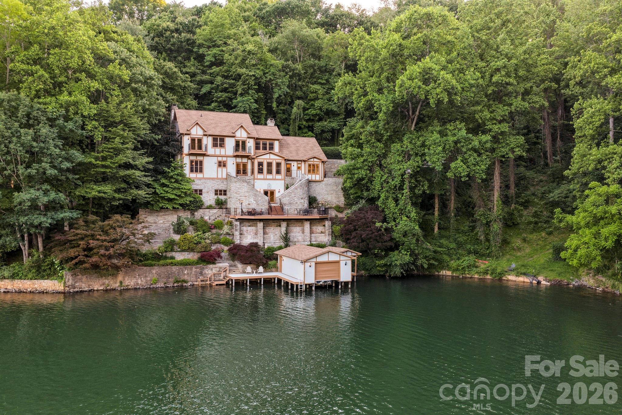 151 Garner Road Lake Lure, NC 28746 - Photo 46 of 48 a view of a lake with a house in the background